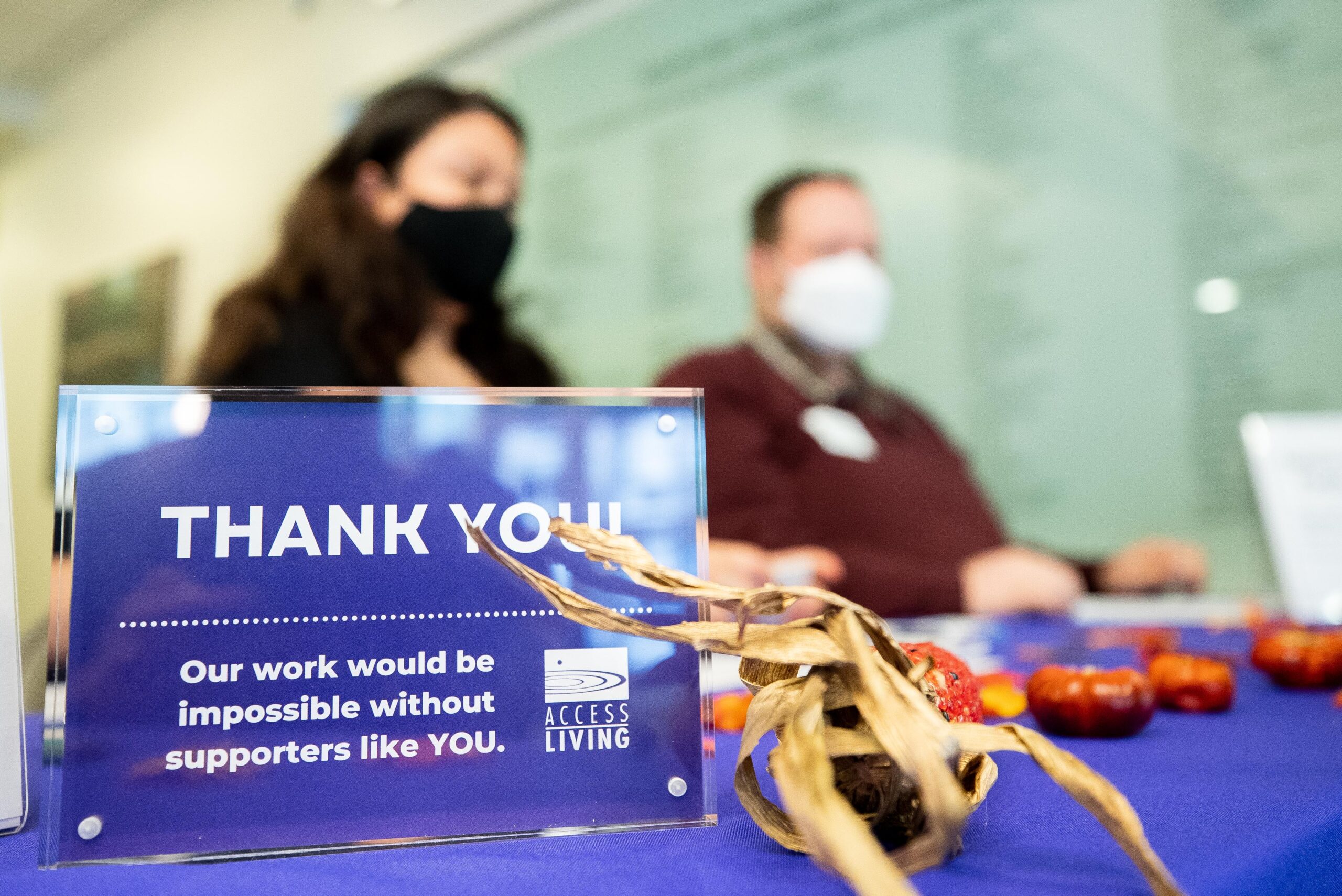 Close-up of an Access Living "Thank You!" sign thanking supporters at an event table.